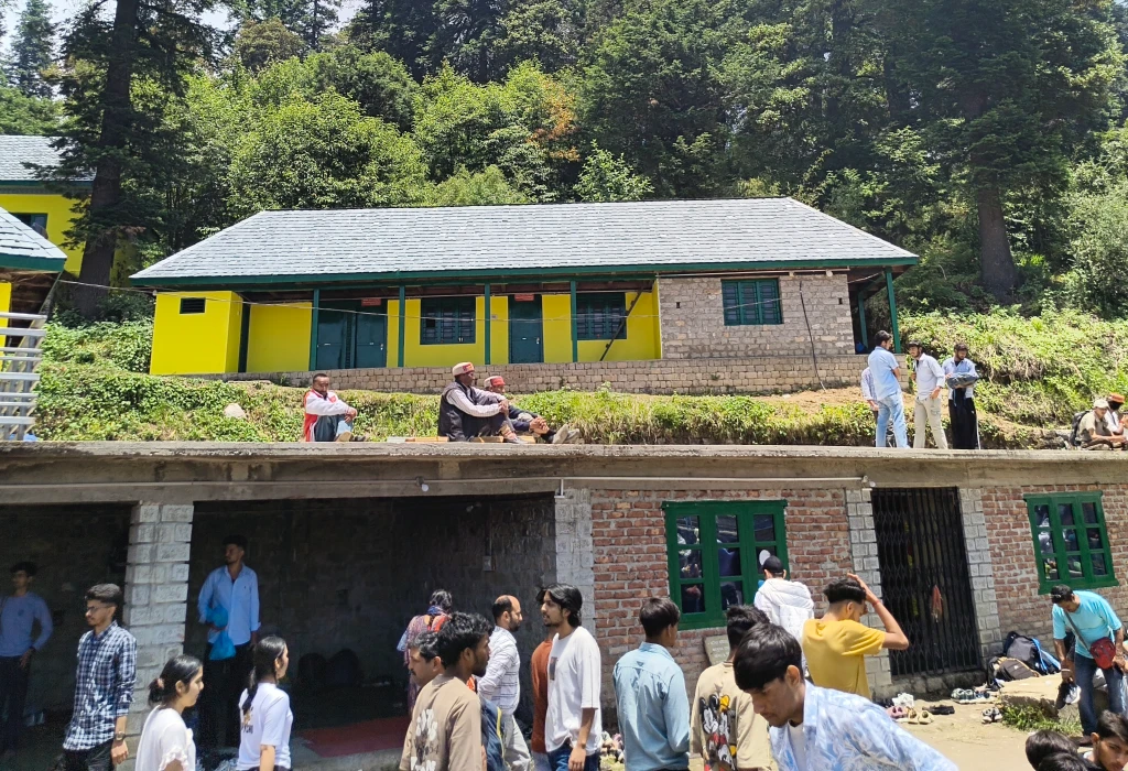Devotees gathered on the meadow during the June Kamrunag fair near the temple